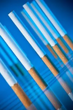 Cigarettes on bright blue background Stock-Fotos