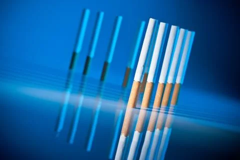 Cigarettes on bright blue background Stock-Fotos