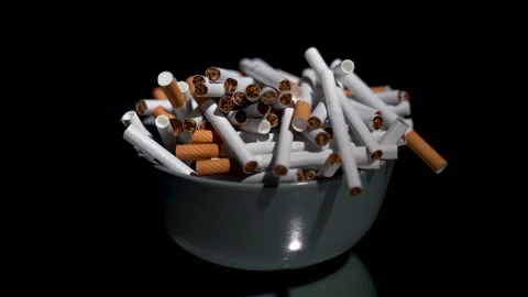 Cigarettes in bulk in a plate on a rotating table Stock Footage 256014943