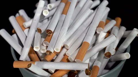 Cigarettes in bulk in a plate on a rotating table