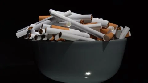Cigarettes in bulk in a plate on a rotating table Stock Footage 256015246