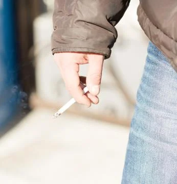 Cigarettes in close-up hands Stock Photos