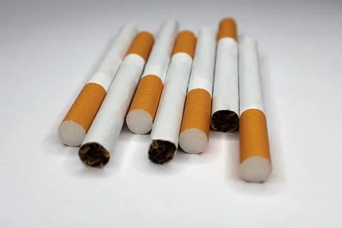 Cigarettes close-up on a light background. The concept of anti-smoking. Stock Photos