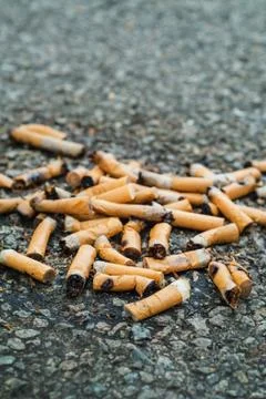 Cigarettes lying on asphalt Stock Photos