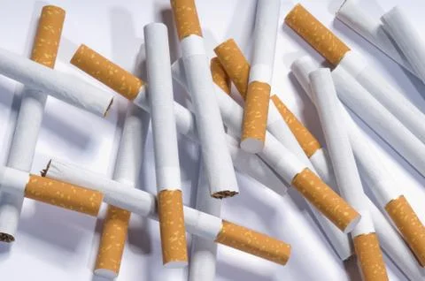 Cigarettes lying on a white background Stock Photos