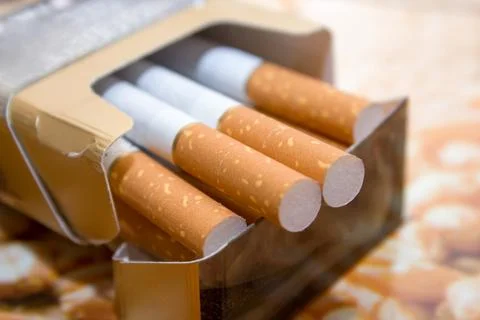 Cigarettes in a pack with a yellow filter Fotos de archivo