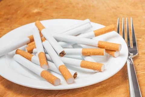 Cigarettes on a plate Stock Photos