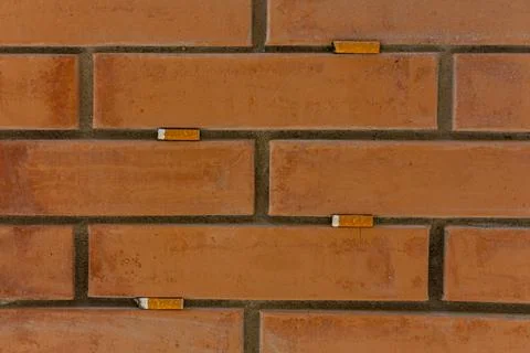 Cigarettes stuck in a wall Stock Photos