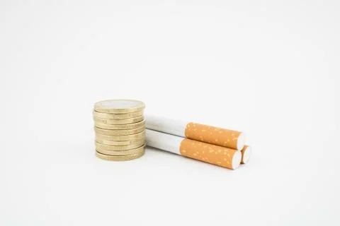 Cigars and stack of coins on white background. Concept of taxs and expenses. Stock Photos