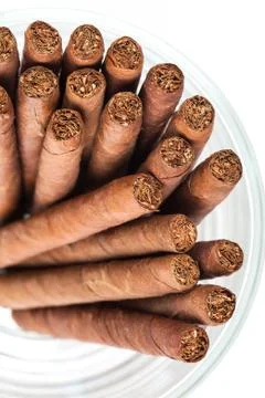 Cigars in the glass on white background Stock Photos