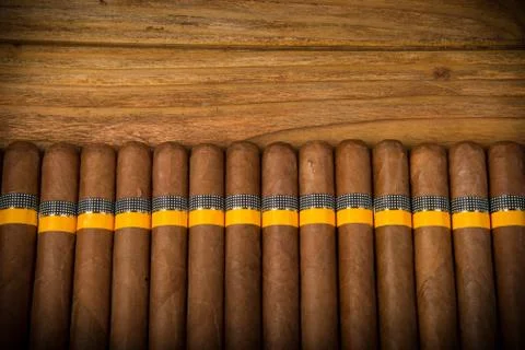 Cigars on rustic table Stock Photos