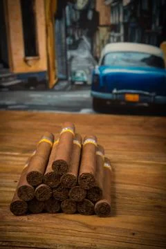 Cigars on rustic table Stock Photos