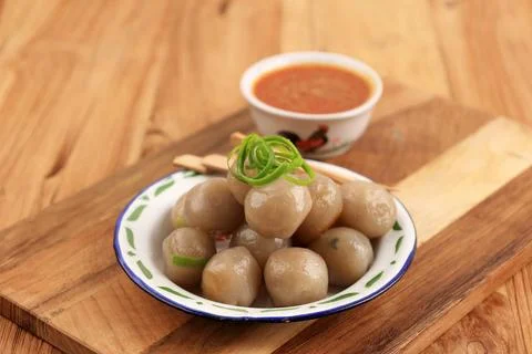 Cilok, Boiled Tapioca Chewy Balls Served with Bumbu Kacang or Peanut Sauce. Stock Photos