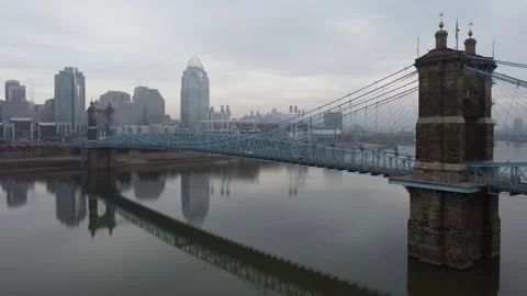 Cincinnati's John A Roebling Suspension Bridge on a foggy morning Stock Footage 221100232