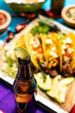 Cinco: Five Tacos On Board With Jalapenos And Avocado Stock Photos
