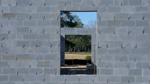 Cinder block construction in progress with rebar Stock Footage 77838793