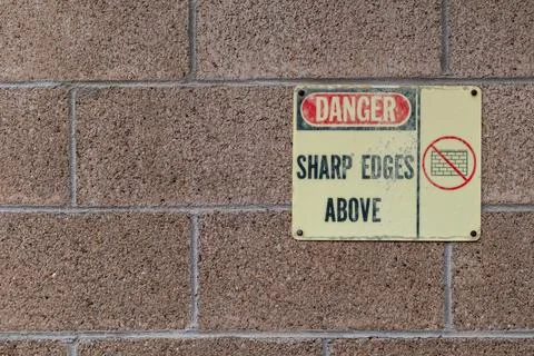 Cinder block wall with danger warning sign and copy space Stock Photos