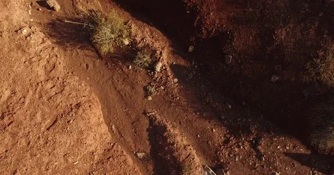 Cinema 4k aerial down facing rising view on a red desert full of large ston.. Stock Footage 72368255
