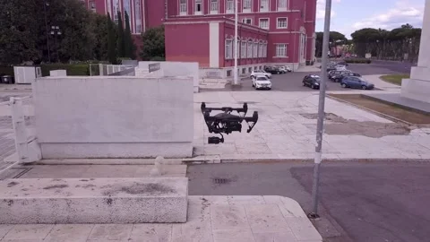 Cinema drone hoovering shooted from another drone Stock Footage 133464470