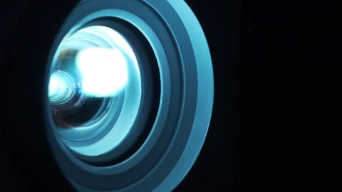 Cinema hall. Close-up of working projector lens.Movie is shown through projector Stock Footage 310011952