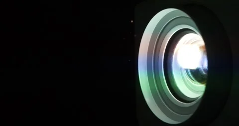 Cinema hall. Projector lens in operation. Movie is shown through projector Stock Footage 279248496