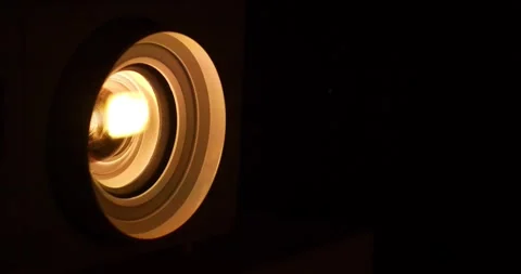 Cinema hall. Projector lens in operation. Movie is shown through projector Stock Footage 279823660