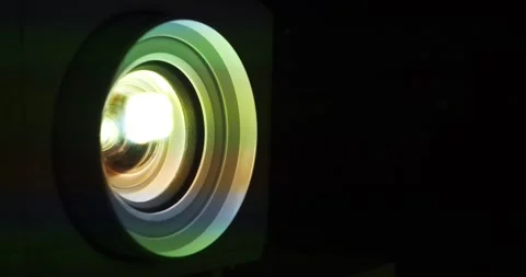 Cinema hall. Projector lens in operation. Movie is shown through projector Stock Footage 280406302