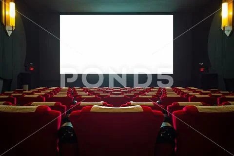 Cinema hall with red seat and wide white screen Stock Photos