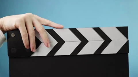 Cinema production process, closeup of a hand holding a clapboard, marking a.. Stock Footage 304134798