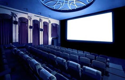 Cinema theater showing empty white movie screen. Stock Photos