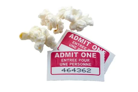 Cinema ticket with popcorn Stock Photos