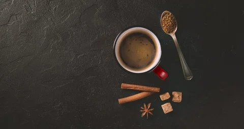 Cinemagrah loop. Coffee mug with cinnamon sticks on dark table. Top view with Stock Footage 122687992