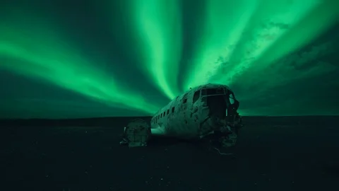 Cinemagraph of aurora borealis in the sky over airplane wreck Stock Footage 122611208