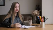 Cinemagraph Of Beautiful Girl Drawing With Pencil, Cup Of Water And Colorful Stock Footage
