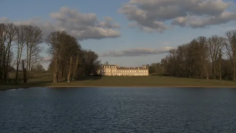 Cinemagraph: Birds Flying In Front of Large Grand House Stock Footage 106572855