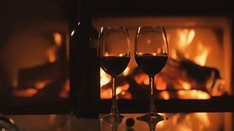 Cinemagraph - Bottle and two red wine  wineglasses over fireplace background. 動画素材 82544340