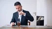 Cinemagraph Of Businessman Sitting At Table And Drinking Tea Stock Footage