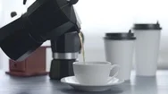 Cinemagraph Of Coffee Pouring In A Cup On A Blue Wooden Table Background  Stock Footage