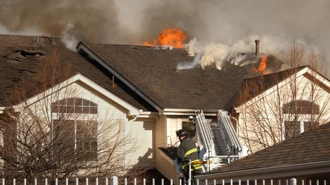 Cinemagraph of Condo Burning with Firefighter Stock Footage 109110023