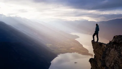 Cinemagraph Continuous Loop Animation of a Man on top of a Mountain Cliff Stock Footage 128791524