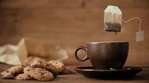 Cinemagraph - Dripping tea bag in a tea cup. Stock Footage 86869092