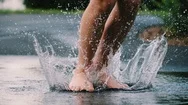 Cinemagraph Of Feet Splashing In Puddle Of Water Stock Footage
