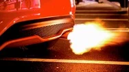Cinemagraph Of Flames Coming From Muffler Of Sports Car On Street Stock Footage