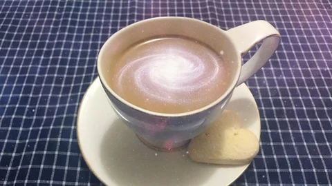 Cinemagraph - Galaxy in the cup of coffee. Steaming white cup of coffee with Stock Footage 100795133