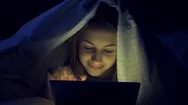Cinemagraph - Girl On The Bed With Tablet. Stock Footage