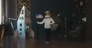Cinemagraph Girl Wearing Cardboard Helmet Pretending To Be Astronaut On Moon Stock Footage
