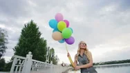 Cinemagraph: Happy Young Girl In The Park With A Bunch Of Colored Balloons Stock Footage
