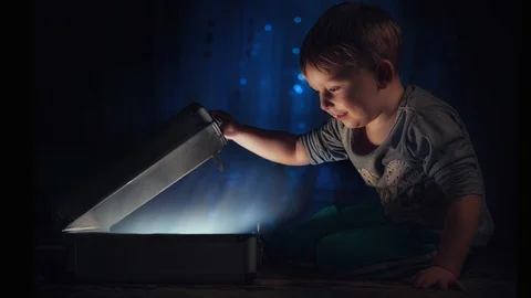 Cinemagraph - Little boy finding treasure inside a suitcase Stock Footage 86847735