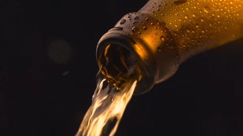 Cinemagraph loop - beer pouring into glass on black background Stock Footage 106924245