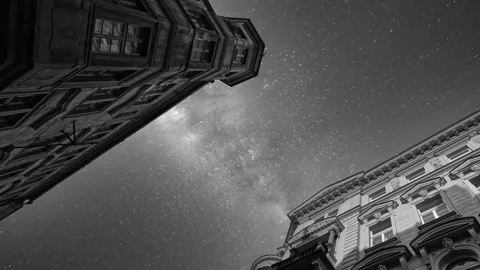 Cinemagraph loop of black and white Milky Way stars over classic  city buildings Stock Footage 154659511